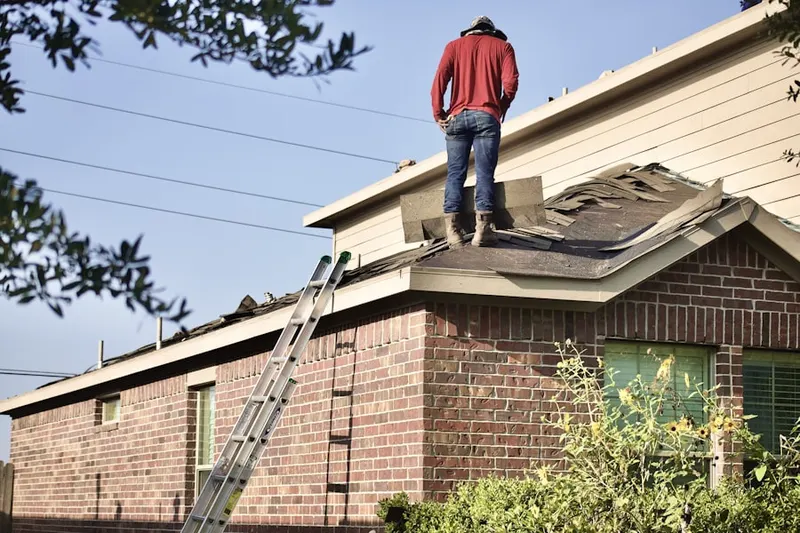 Professional roofer working on a residential roof in East Bakersfield